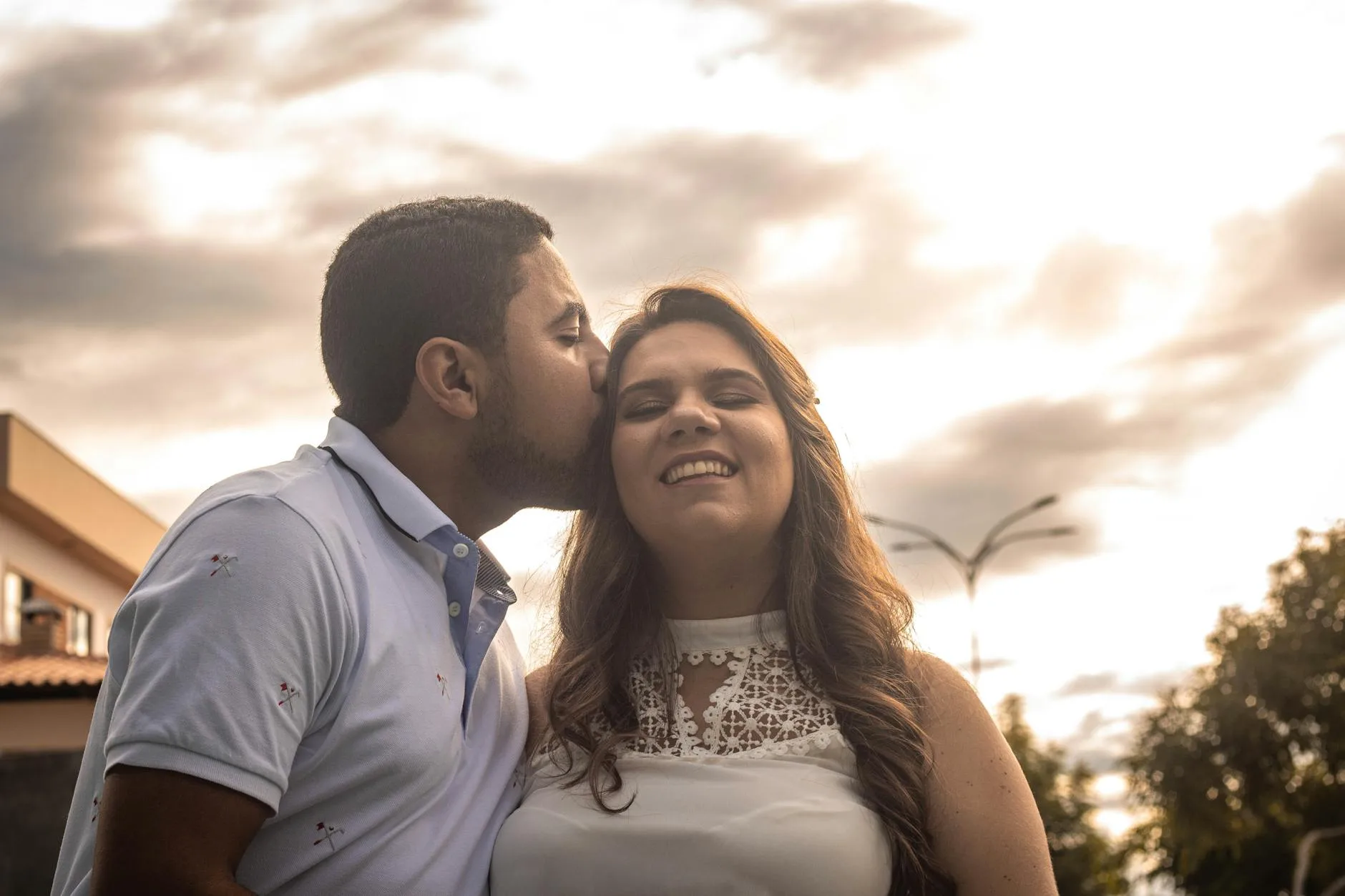 Joyful couple sharing an affectionate outdoor moment — what a compatible introduction from a dating agency can lead to