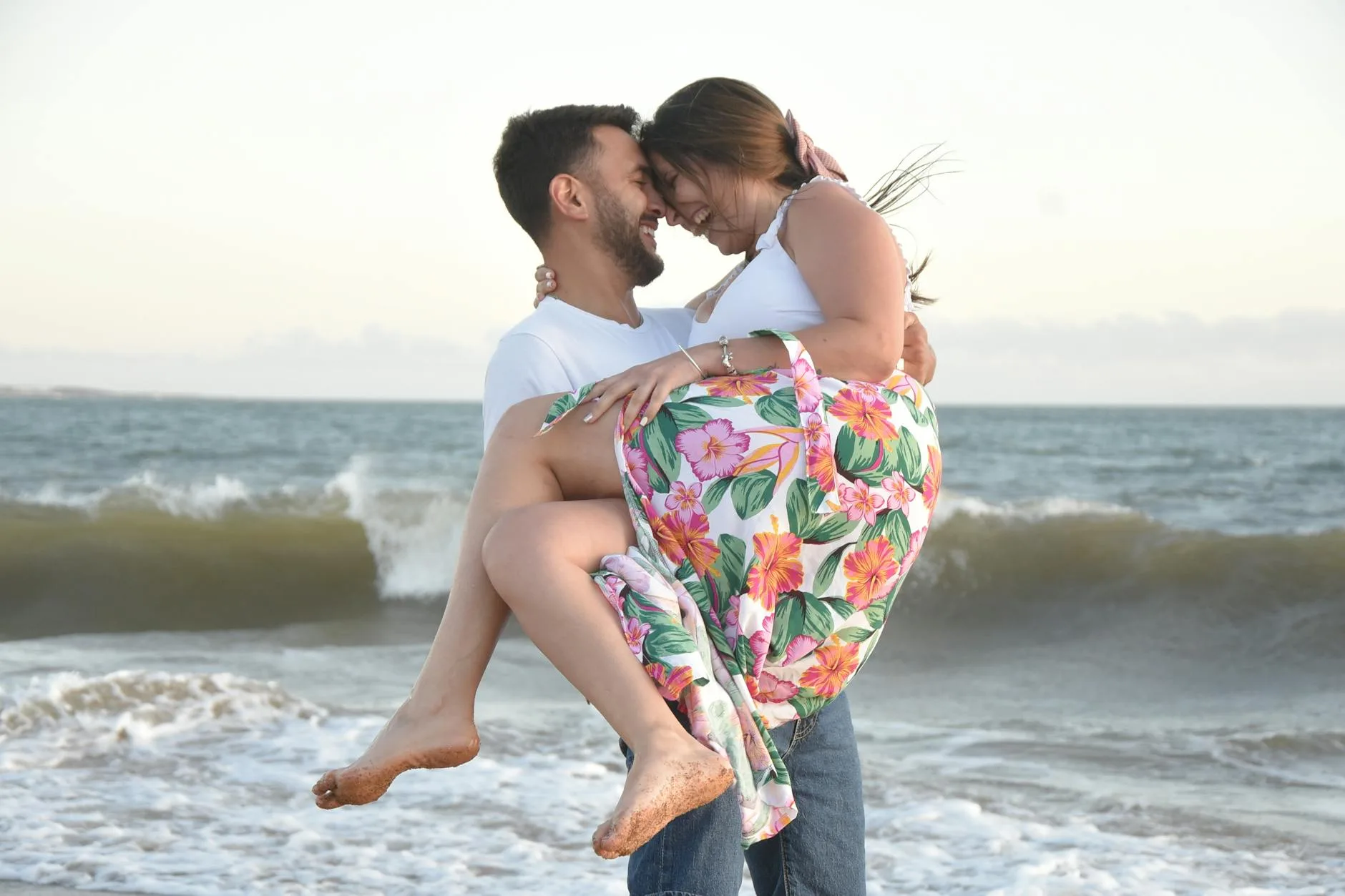 Couple laughing together by the ocean — the kind of meaningful connection LA's professional matchmakers help create